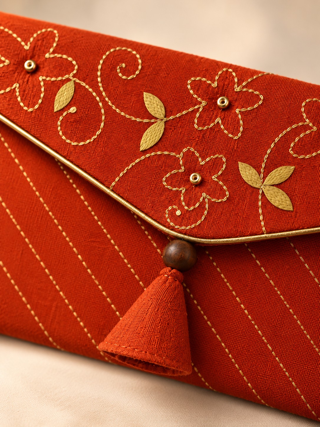 Close-up of hand embroidery on the Gerua Khadi shagun envelope