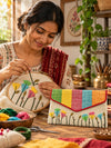 Artisan hand embroidering Khadi shagun envelope